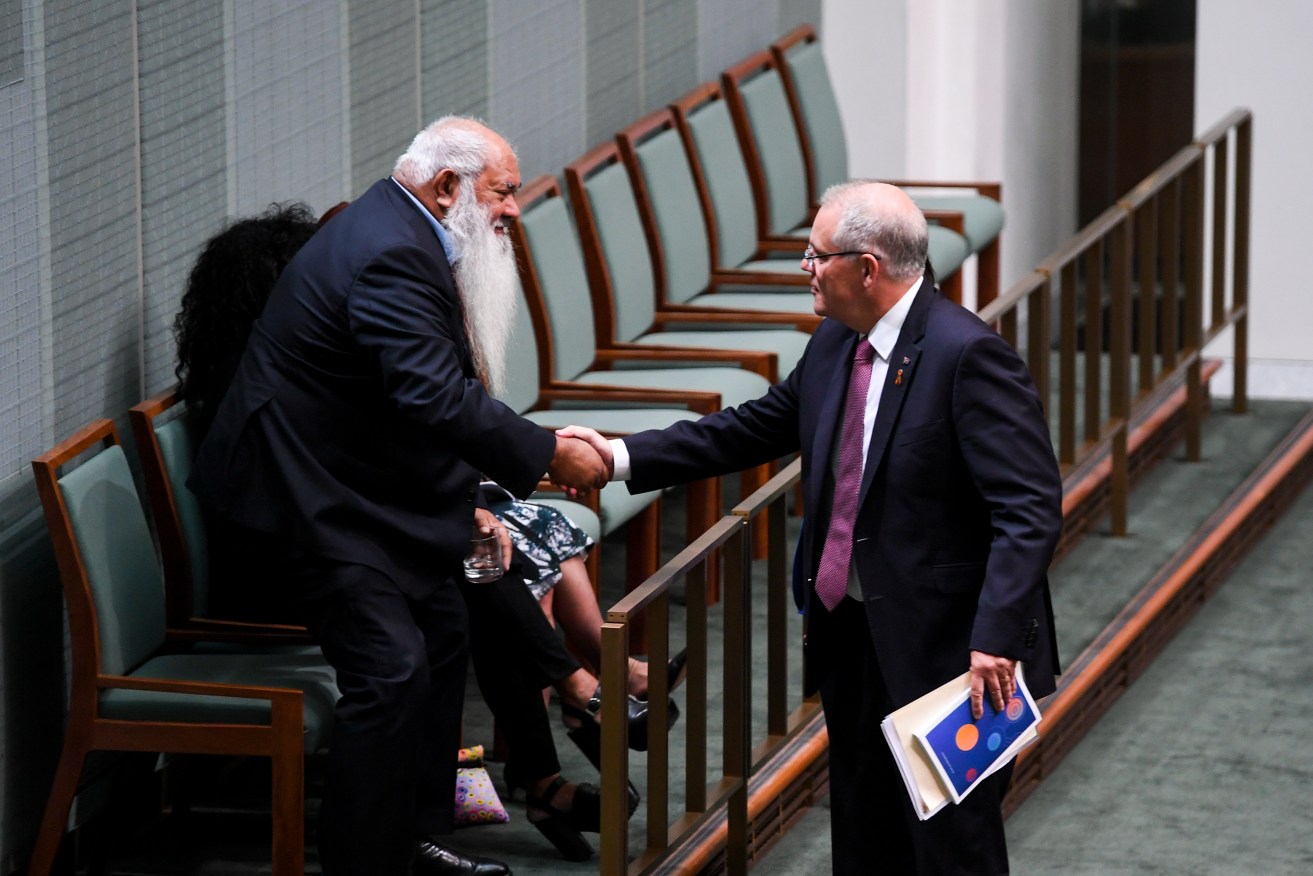 Prime Minister Scott Morrison (right) shakes hands with Labor Senator Pat Dodson as he arrives to deliver the Closing the Gap report in the House of Representatives today. Photo: AAP/Lukas Coch