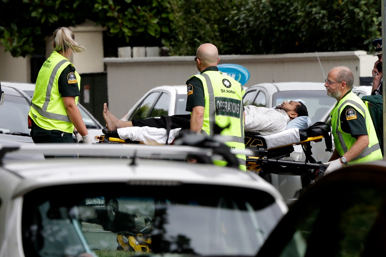 Ambulance staff take a man from outside a mosque in central Christchurch. Photo: Mark Baker / AP