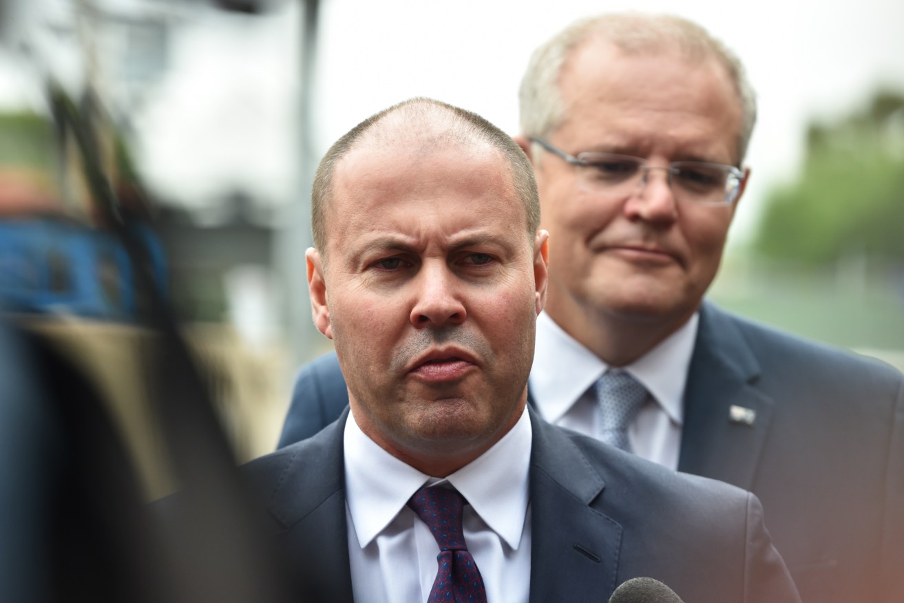 Treasurer Josh Frydenberg (left) and Prime Minister Scott Morrison are planning to empty the Federal Government's coffers. Photo: AAP/James Ross