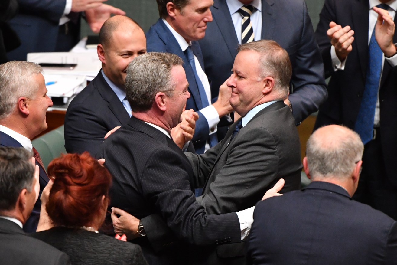 Anthony Albanese embraces Christopher Pyne as Josh Frydenberg looks on yesterday. Photo: Mick Tsikas / AAP