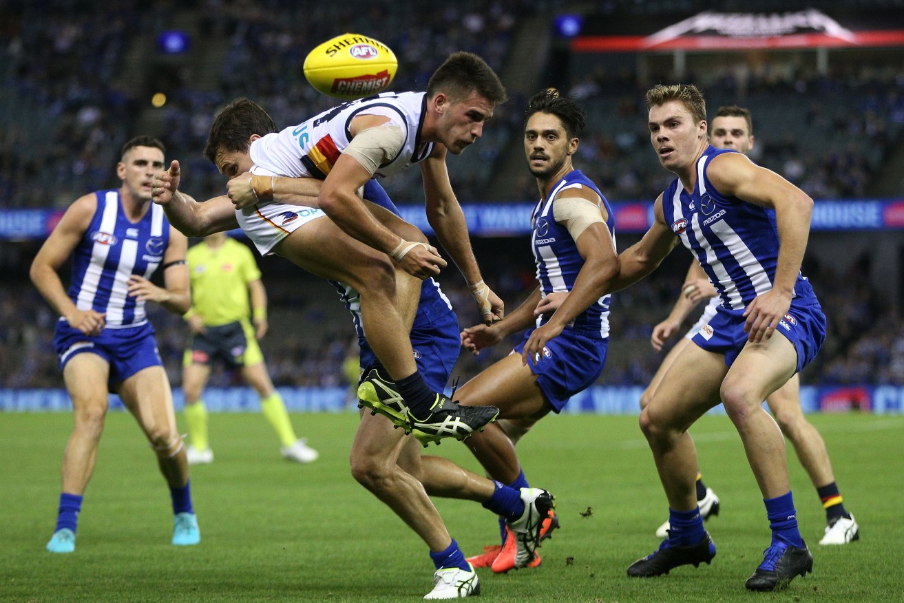 Lachie Murphy is crunched by Scott Thompson (the one who plays for the Kangaroos, not the good one). Photo: Hamish Blair / AAP