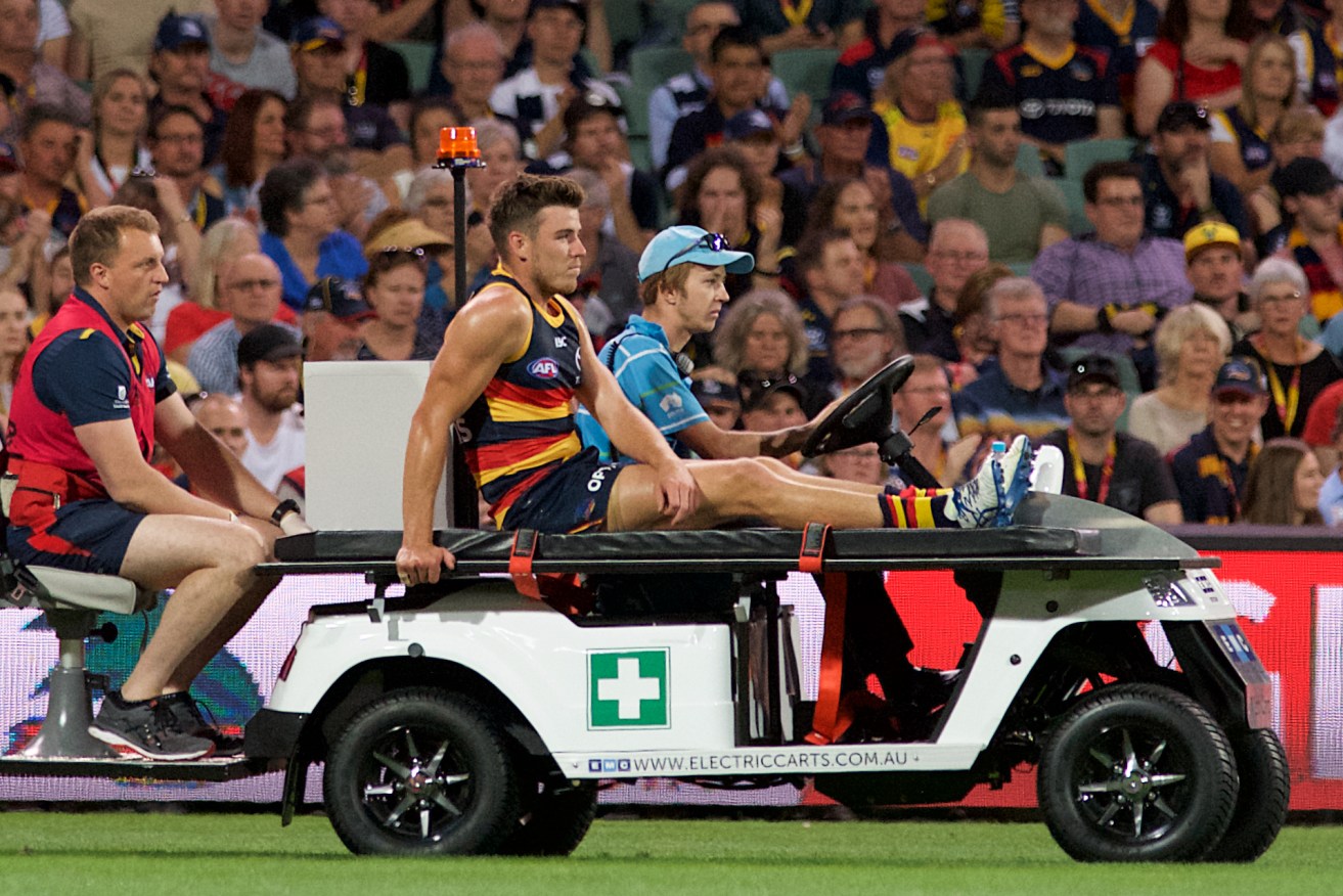 Paul Seedsman is carried from the ground after injuring his knee. Photo: Michael Errey/InDaily
