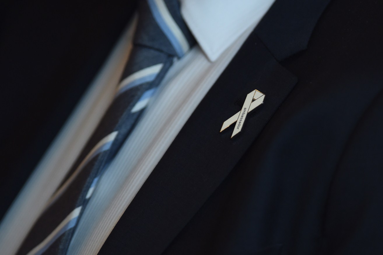 Organisations and businesses can become accredited with White Ribbon. Photo: AAP/Lukas Coch