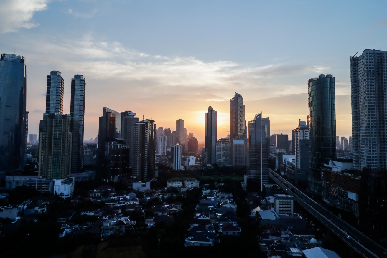 The sun sets over the central business district skyline in Jakarta. Indonesia plans to set up a new capital city as Jakarta struggles with bad traffic, pollution and flooding. Photo: EPA/Mast Irham
