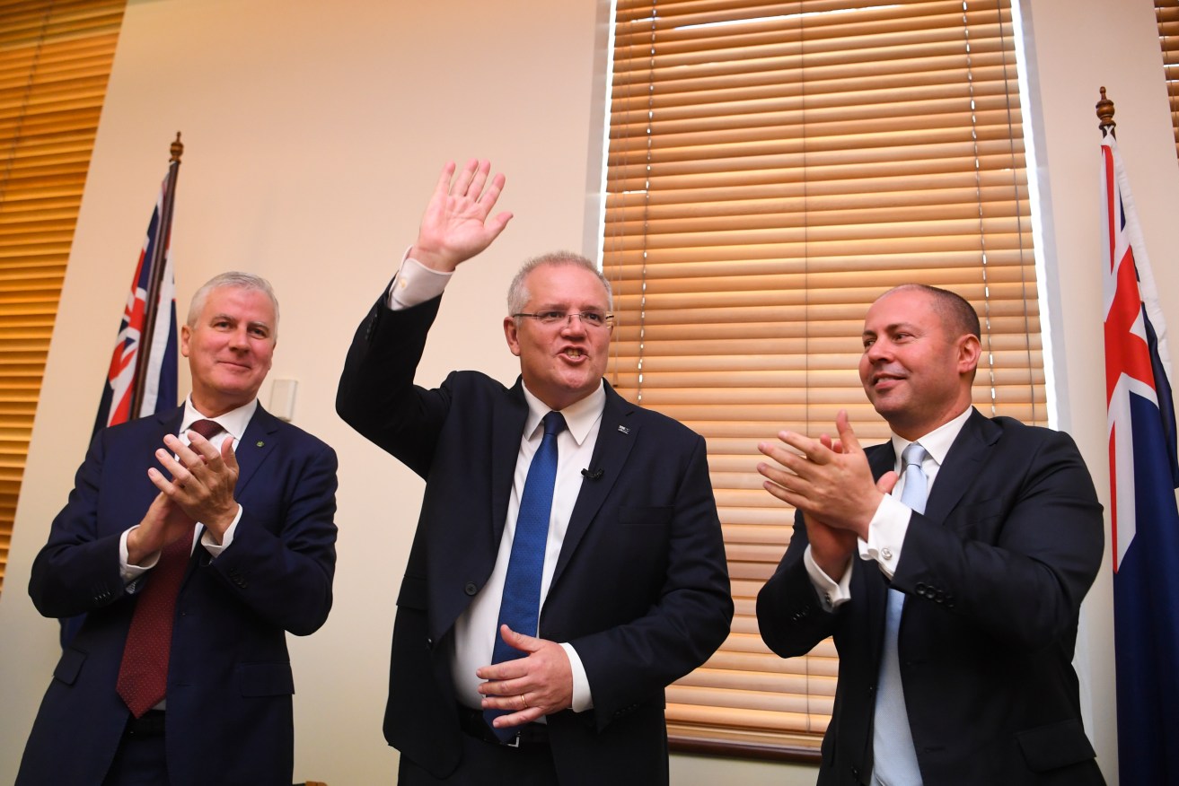Scott Morrison is congratulated by the Coalition partyroom. Photo: AAP/Lukas Coch