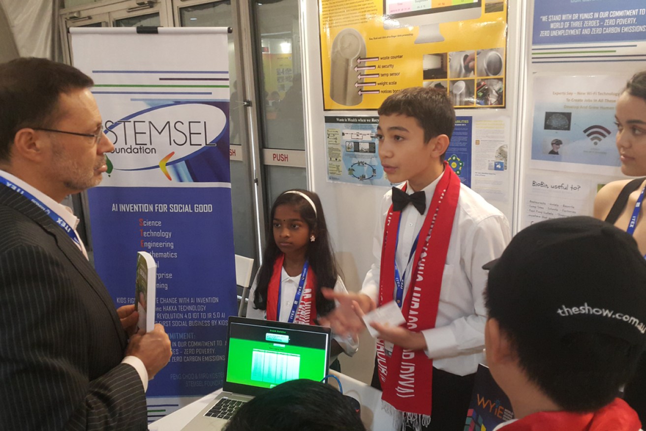 Max Weir explains his device to Australia's High Commissioner at Malaysia's World Young Inventors Exhibition.
