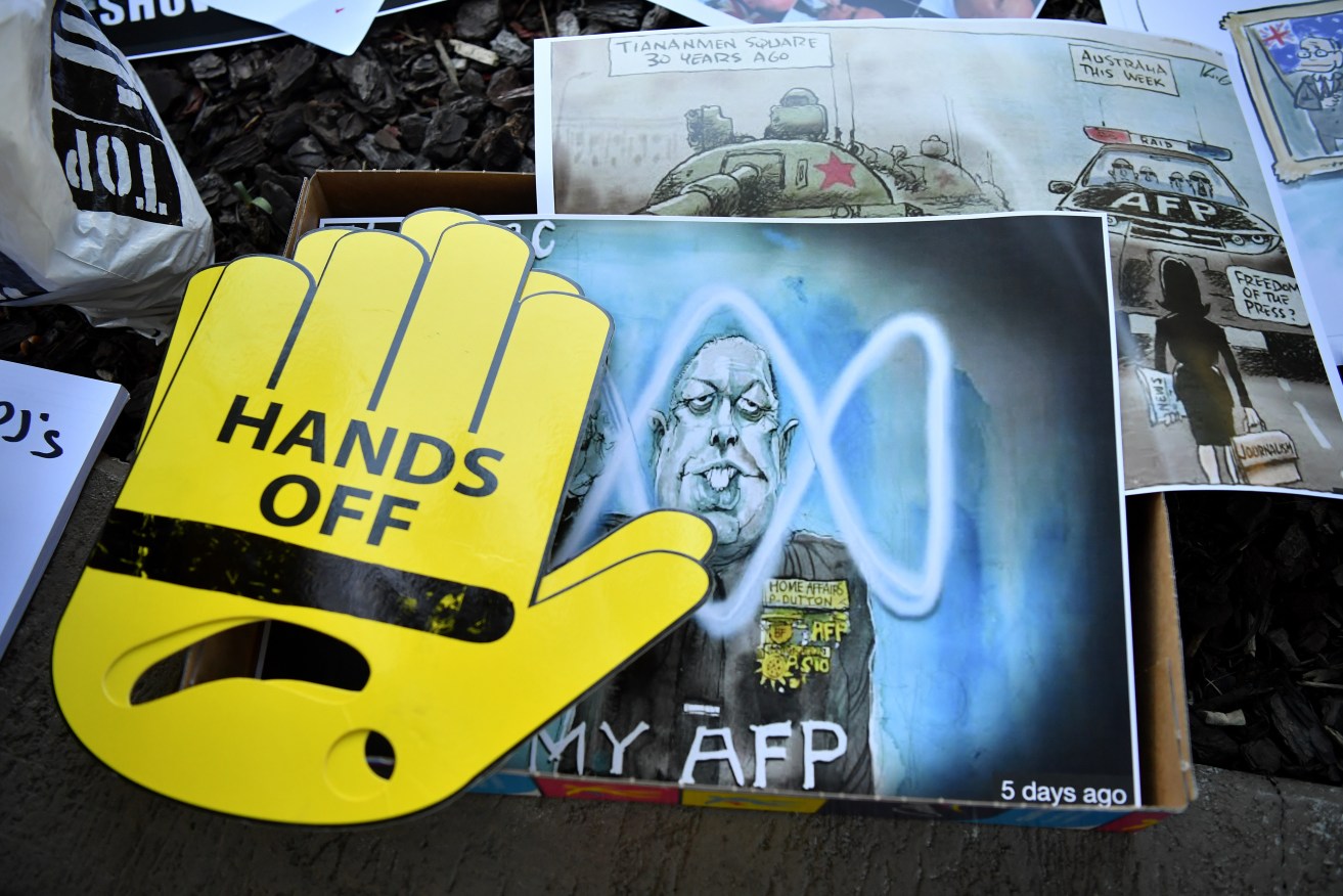 Signs from a Sydney rally to protect press freedom after AFP raids. Photo: AAP/Joel Carrett