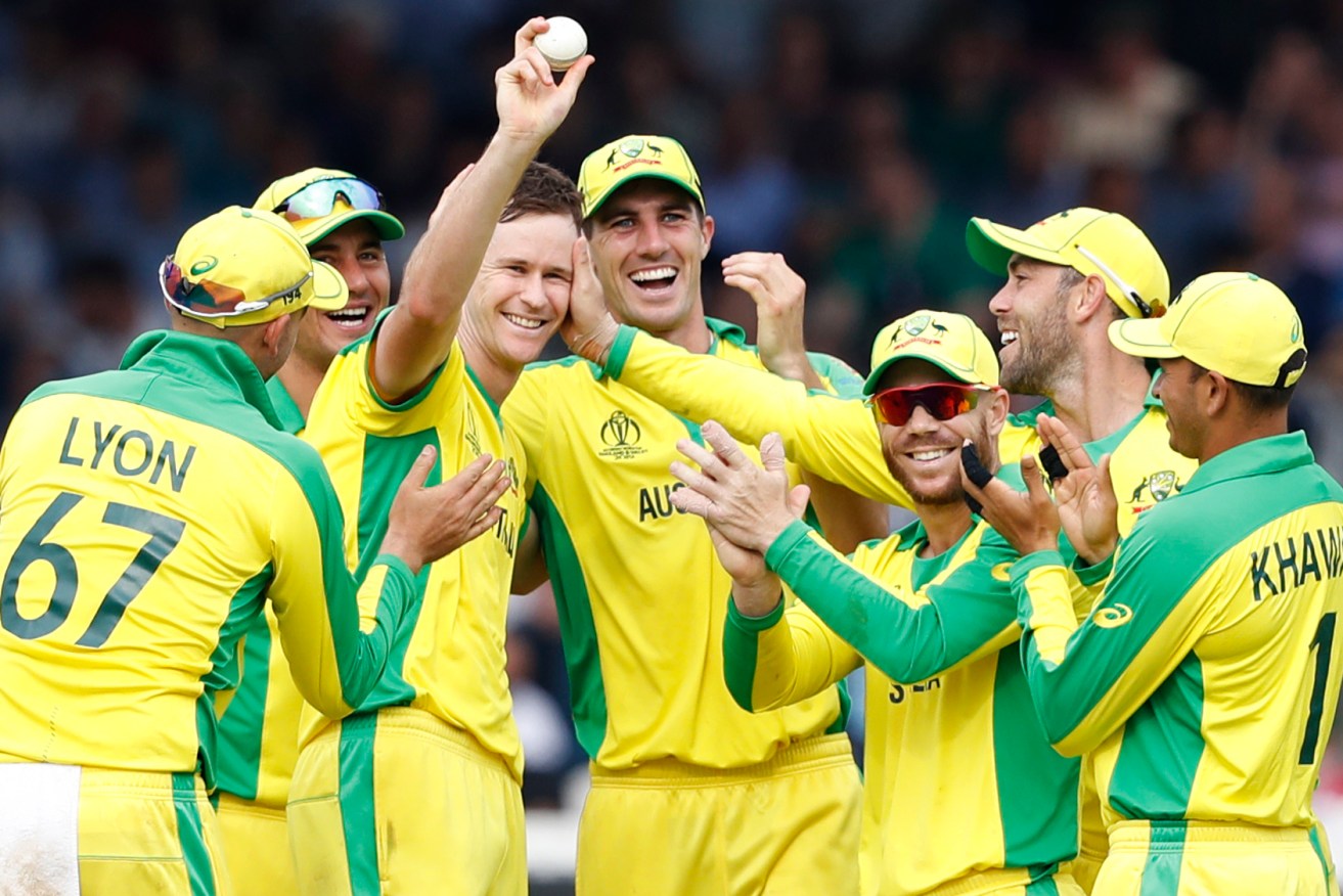 Jason Behrendorff celebrates with teammates after taking one of his five wickets against England. Photo: AP/Alastair Grant