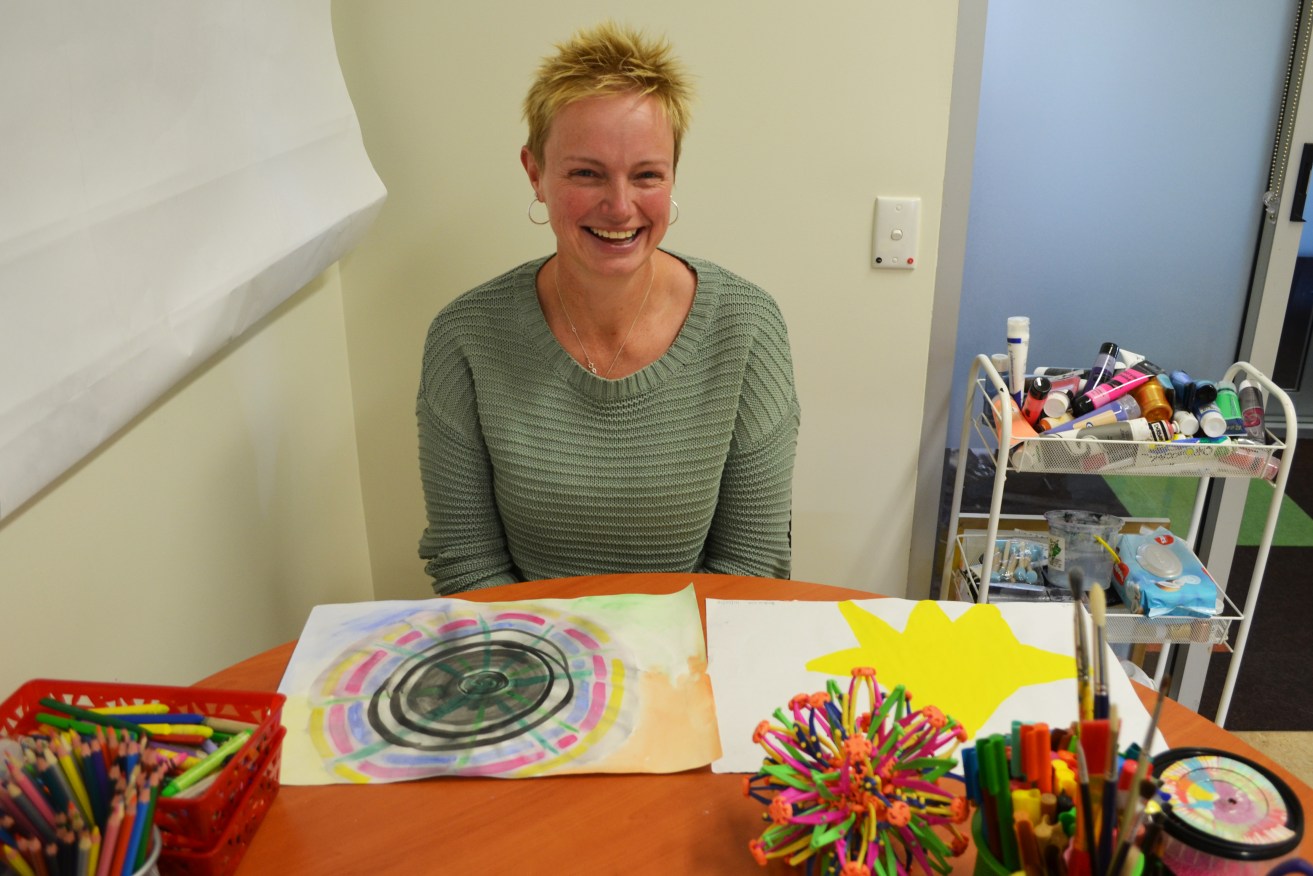 Kerrie with the results of an art therapy session. The star has special significance for her progress. Photo: Angela Skujins