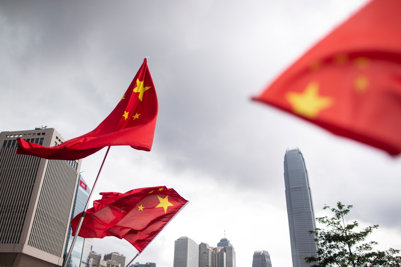 Chinese national flags being waved at a rally to support police ahead of another expected protest today. Photo: supplied