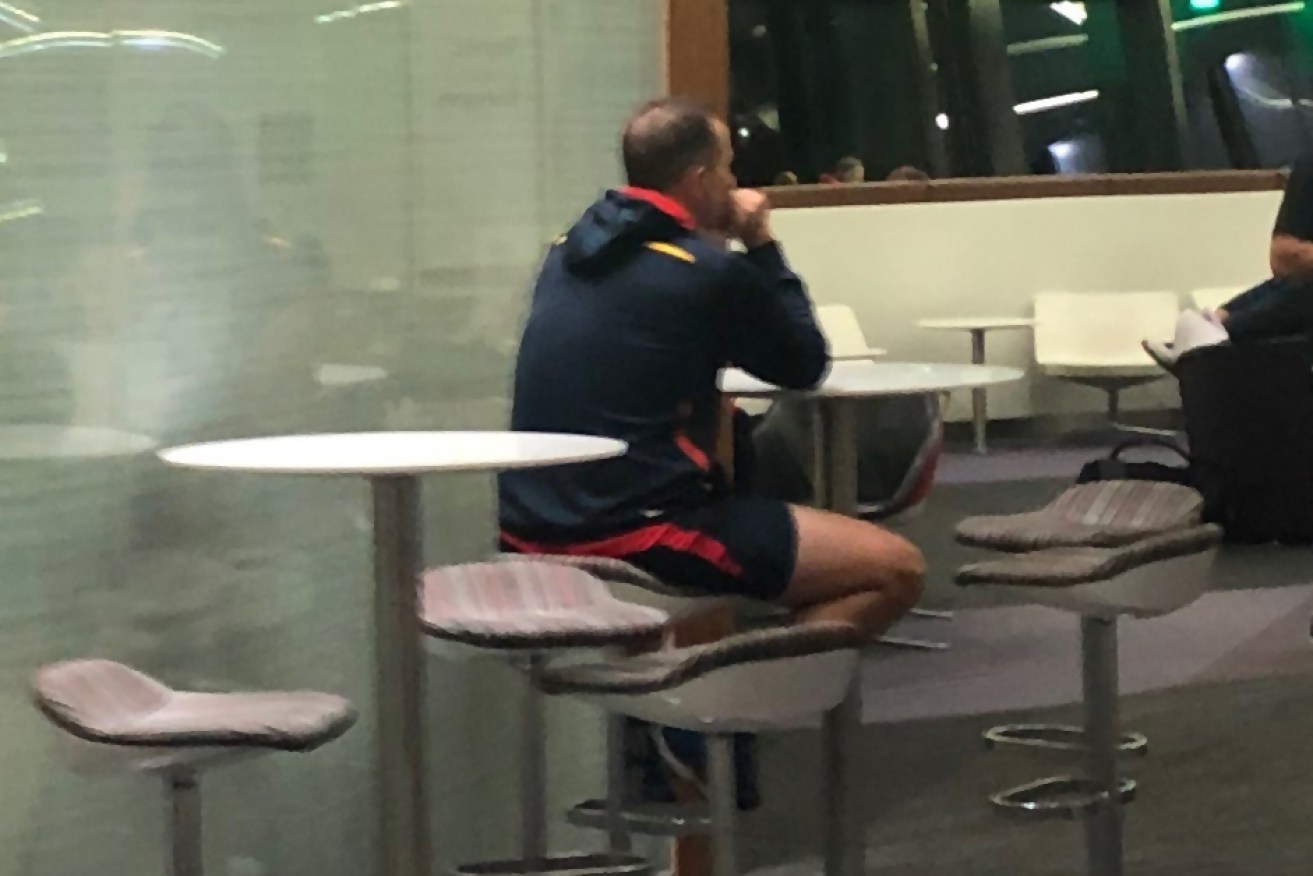 MR LONELY: Don Pyke cuts a poignant figure at Melbourne airport after the Crows' loss to Carlton.