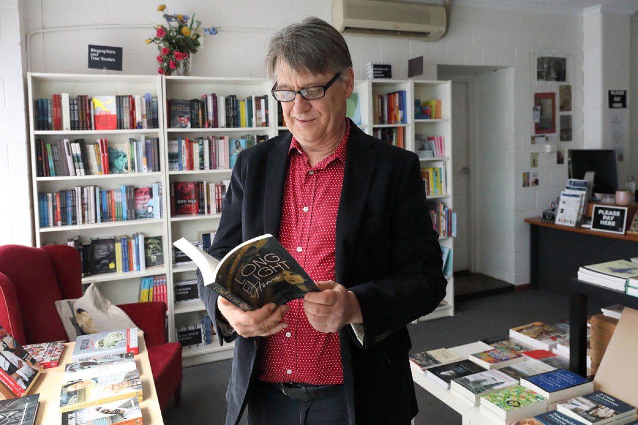 Wakefield Press publisher Michael Bollen with new novel Long Flight Home. Photo: Tony Lewis / InDaily