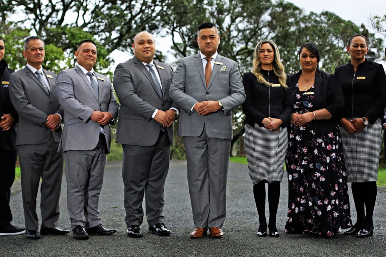 Francis and Kaiora Tipene (centre) with their staff and fellow stars of The Casketeers.