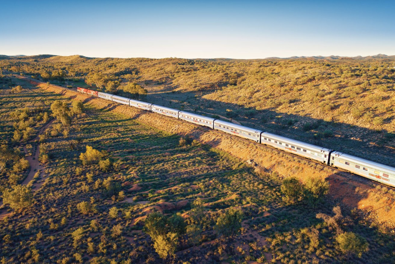 The Ghan heading north of Alice Springs through the MacDonnell Ranges. Photo: supplied