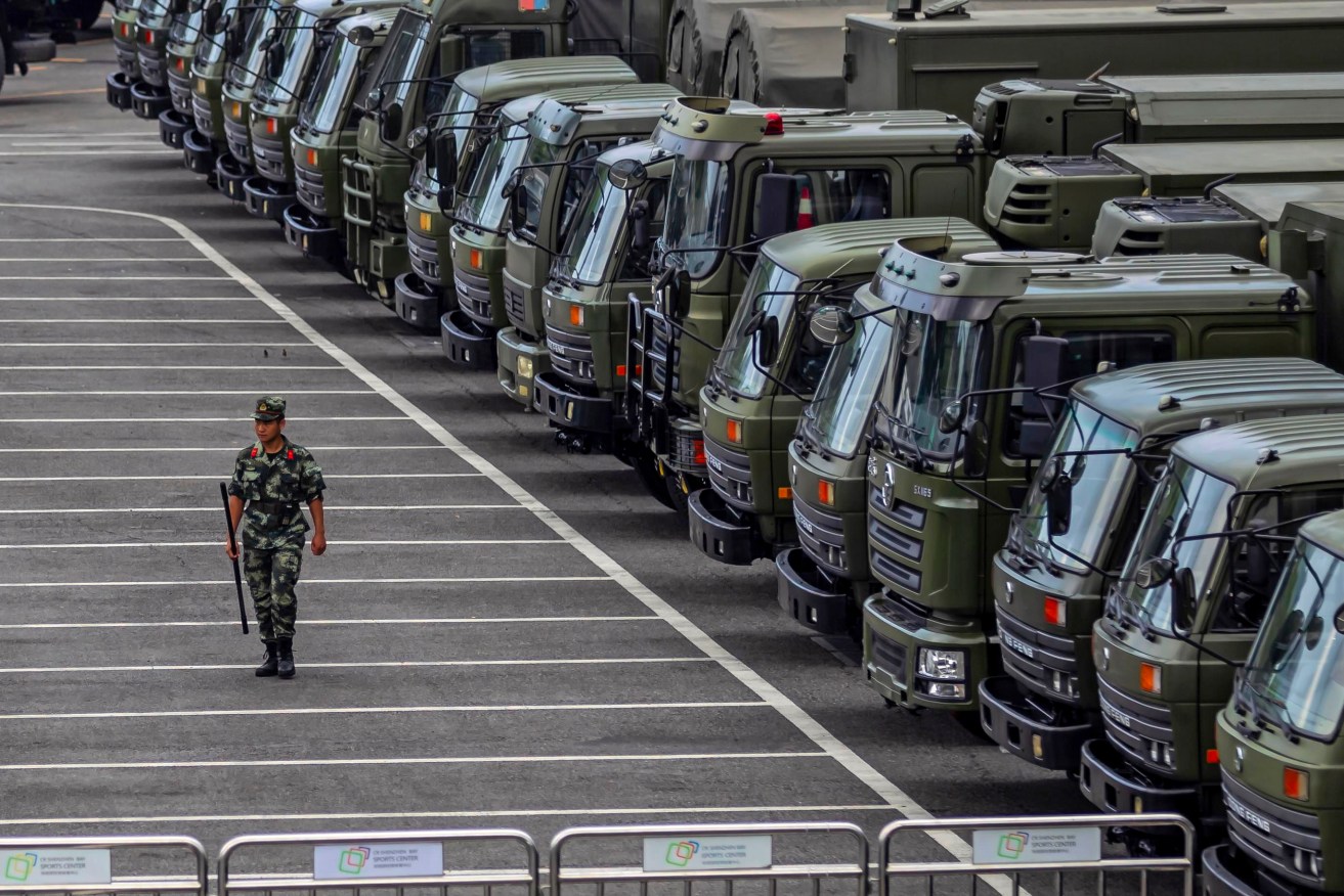 China's paramilitary police and vehicles including armoured personnel carriers have gathered at Shenzhen, across the border from Hong Kong. Photo: AP/Alex Plavevski