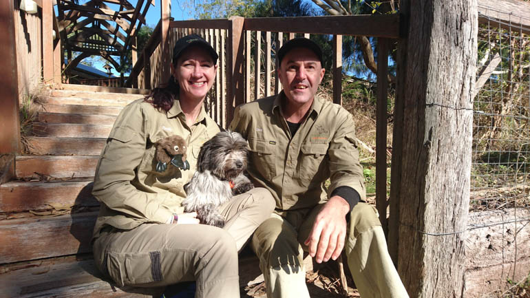 Warrawong Wildlife Sanctuary owners Narelle MacPherson and David Cobbold with four-legged friend, Bear. Photo courtesy of Weekender Herald.