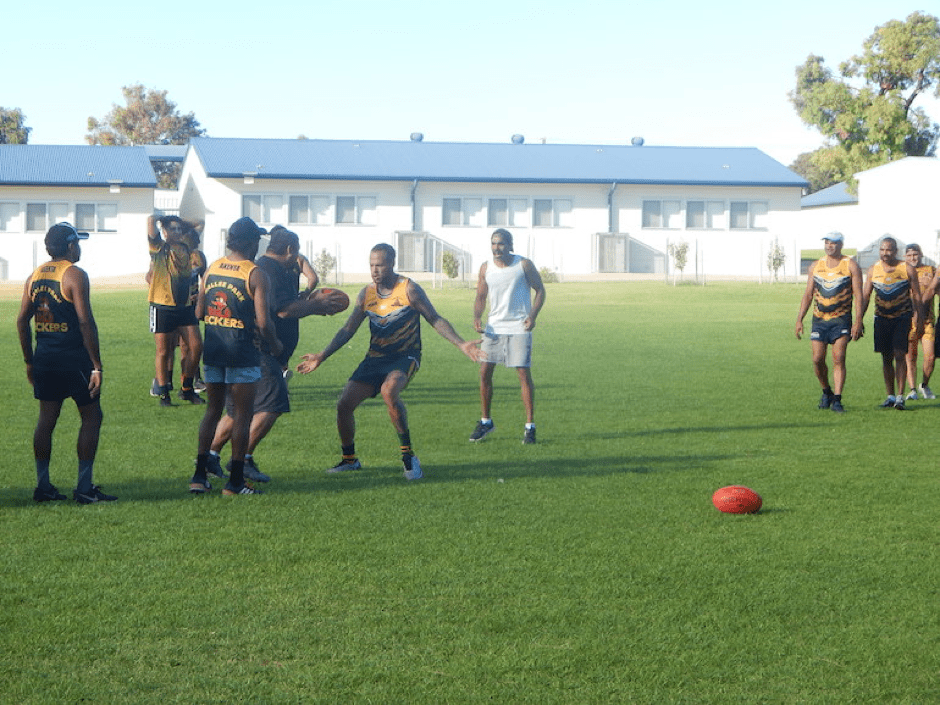Crows star footballer and former Peckers player Eddie Betts, centre, trains with the team in Port Lincoln.