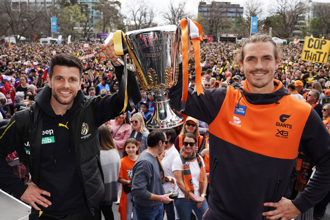 Trent Cotchin of the Tigers and Phil Davis of the Giants pose with the Premiership Cup during the AFL Grand Final Parade in Melbourne. Photo: Michael Dodge / AAP