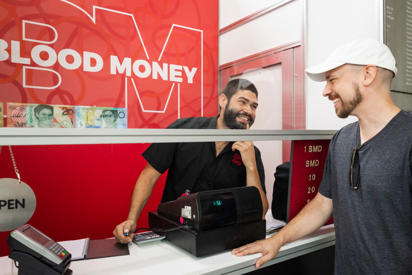 Ryan Presley (right) with his Blood Money Currency Exchange Terminal at the Museum of Contemporary Art Australia in Sydney. 
 Photo: Jacquie Manning
