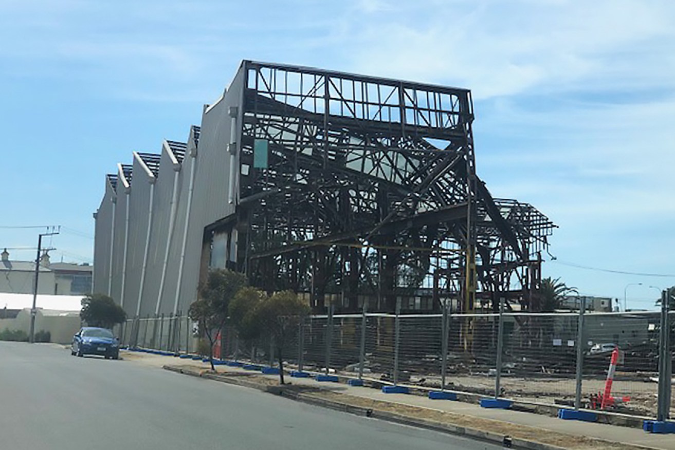 A photograph supplied by the CFMEU appears to show the wall of the building bowing, with a car parked nearby. 