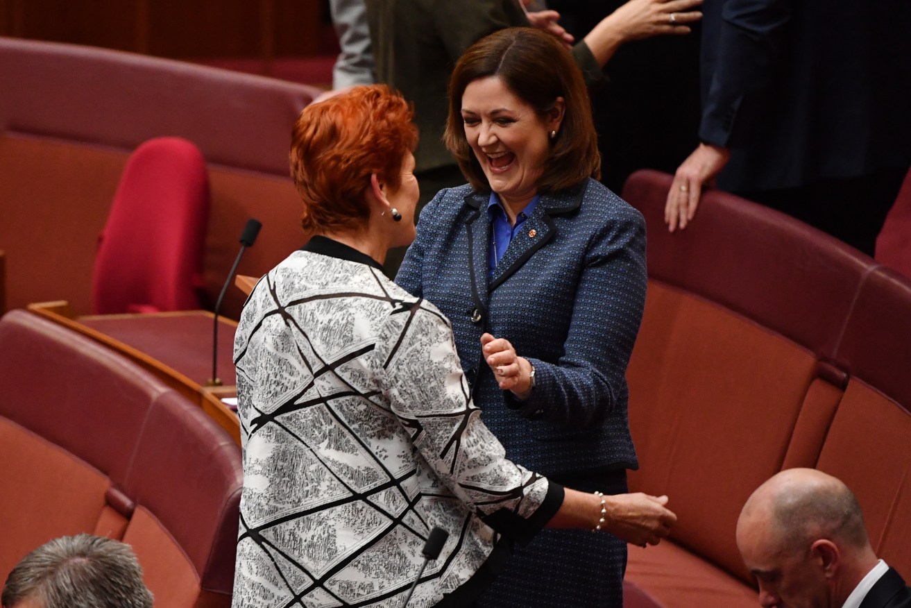 Liberal Senator Sarah Henderson is congratulated by Pauline Hanson following her maiden speech. Photo: AAP/Mick Tsikas