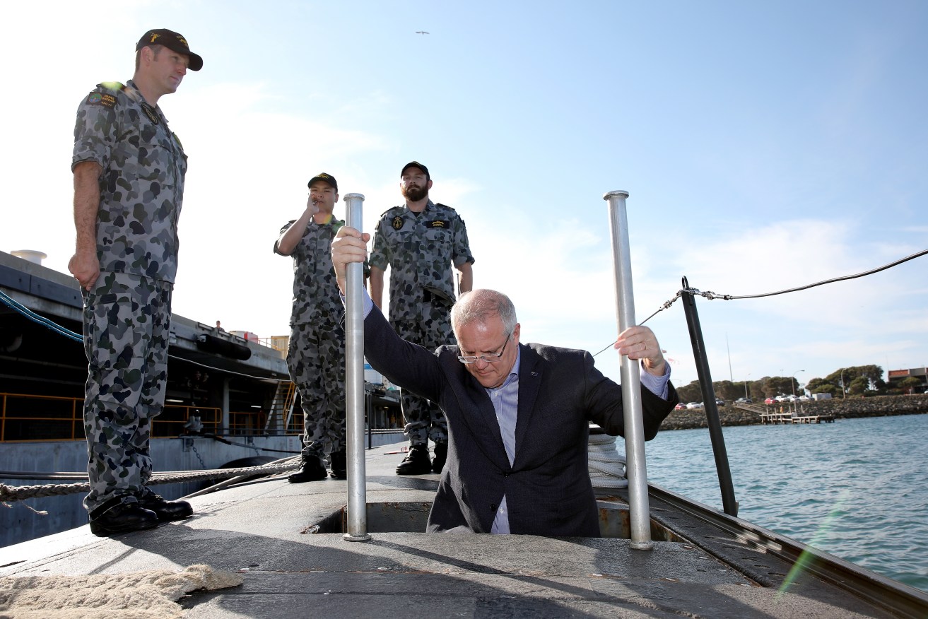 Prime Minister Scott Morrison gets on board a a Collins Class submarine based at HMAS Stirling near Perth. Photo: AAP/Richard Wainwright