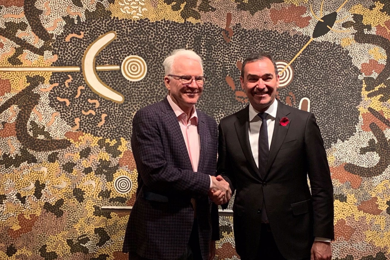 Actor Steve Martin and Premier Steven Marshall with Clifford Possum Tjapaltjarri's 'Man's Love Story' at the AGSA.