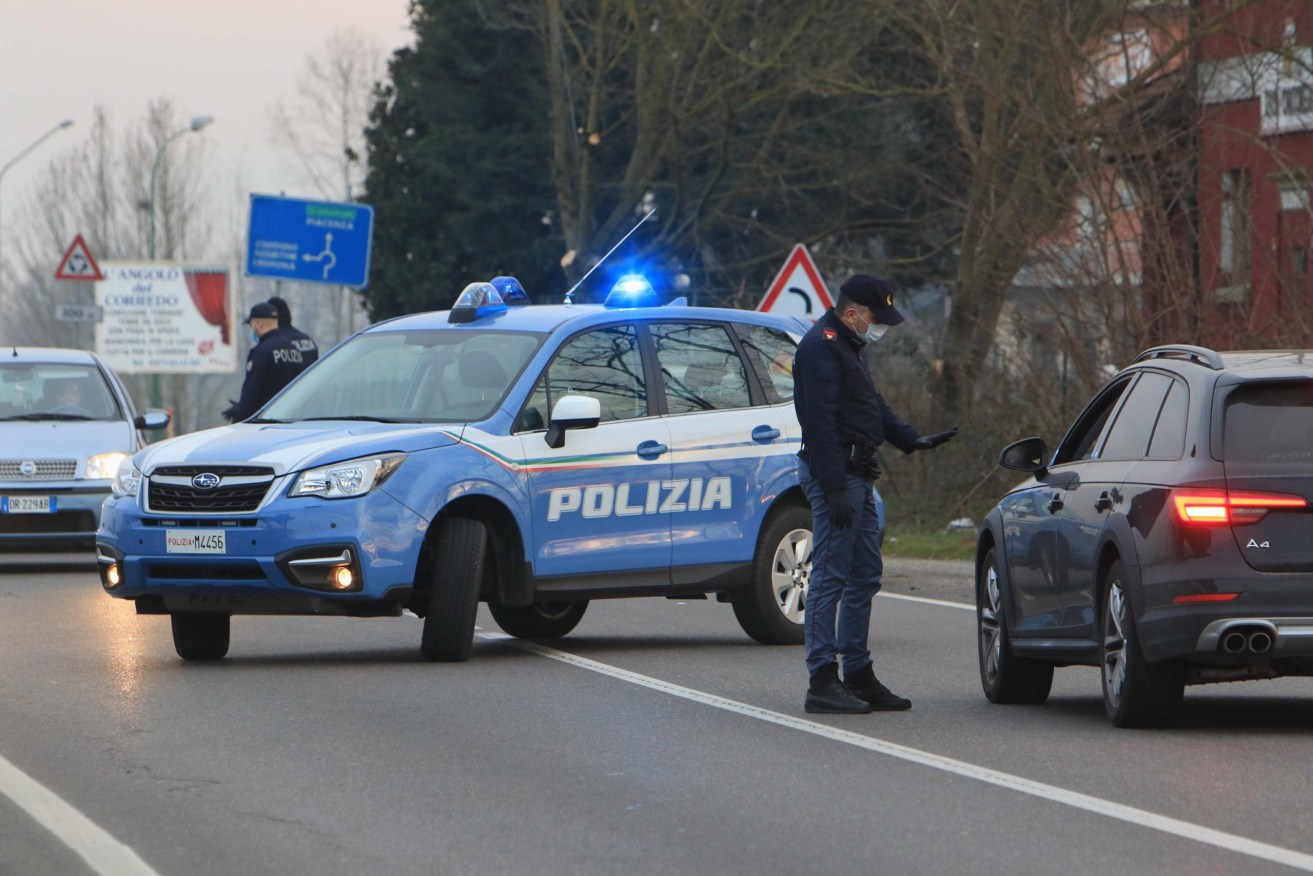 Police near Milan check movement in and out of a town under quarantine. Photo: supplied