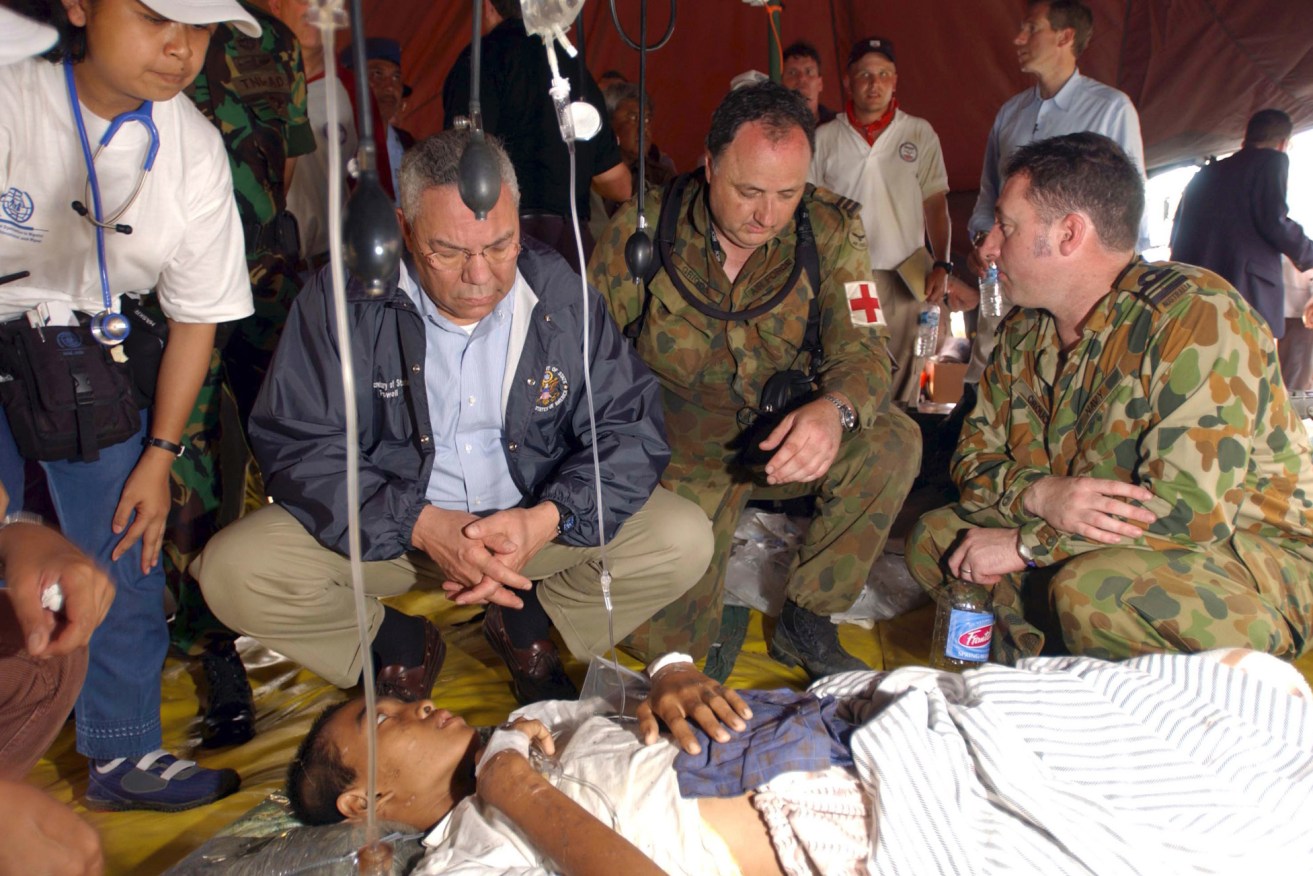 Dr Bill Griggs with then-US Secretary of State Colin Powell in tsunami-ravaged Banda Aceh in 2005. Photo: AAP
