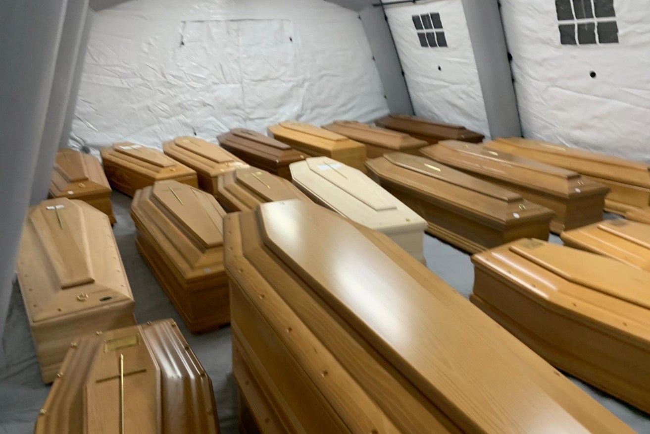 The coffins of the coronavirus dead are piled up in the church of Every Saints in the cemetery in Bergamo, Italy. Photo: EPA/Tiziano Manzoni