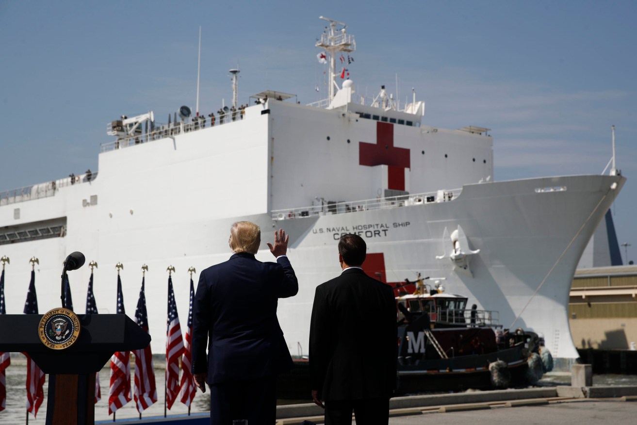 Donald Trump farewells a US Navy hospital ship heading to New York to help virus patients. Photo: AP/Patrick Semansky