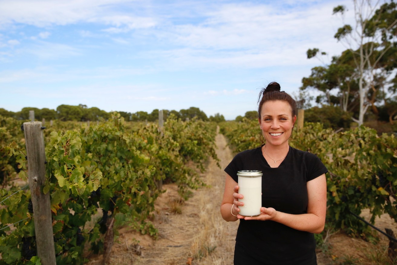 Caleigh Hunt with a jar of fresh milk on her property at Willunga. Photo: Ben Kelly.