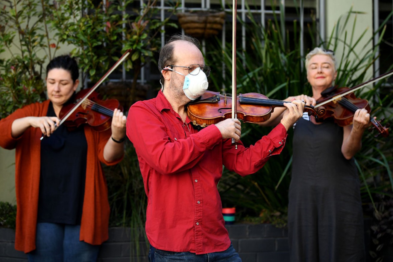 Members of the Opera Australia Orchestra perform outside OA's offices last Thursday to call on the company to reconsider its decision to stand down musicians without pay. Photo: AAP