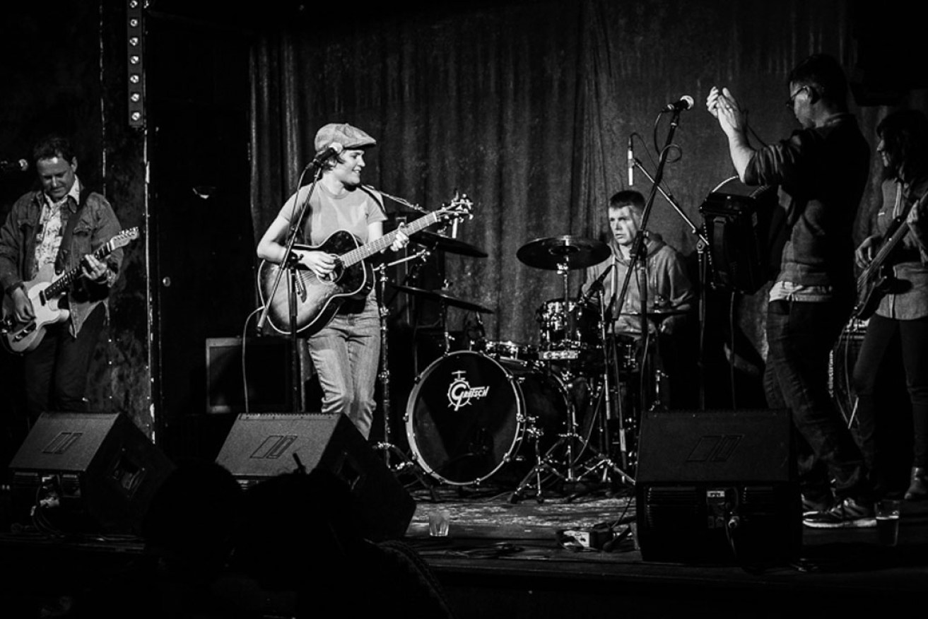 Singer-songwriter Kelly Menhennett at a (pre-COVID-19) gig with her band. Photo: Max Moore