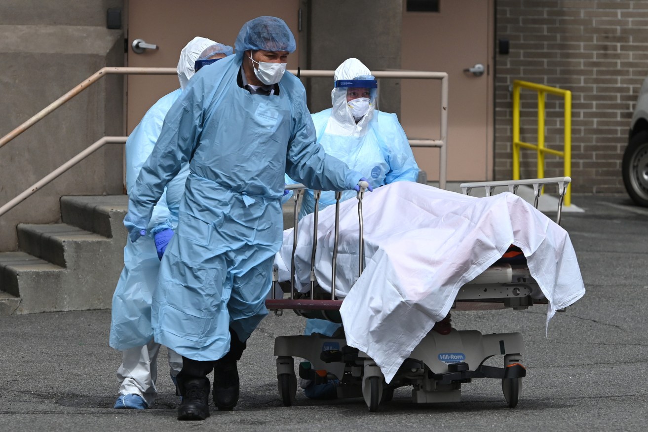 A body is moved to an overflow morgue outside a New York hospital. Photo: Anthony Behar/Sipa USA
