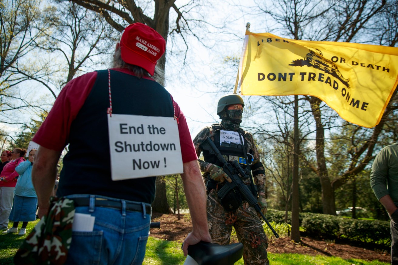 Armed protesters gather outside the Indiana Governor's residence demanding virus restrictions be lifted.  Photo: Jeremy Hogan/SOPA Images/Sipa USA