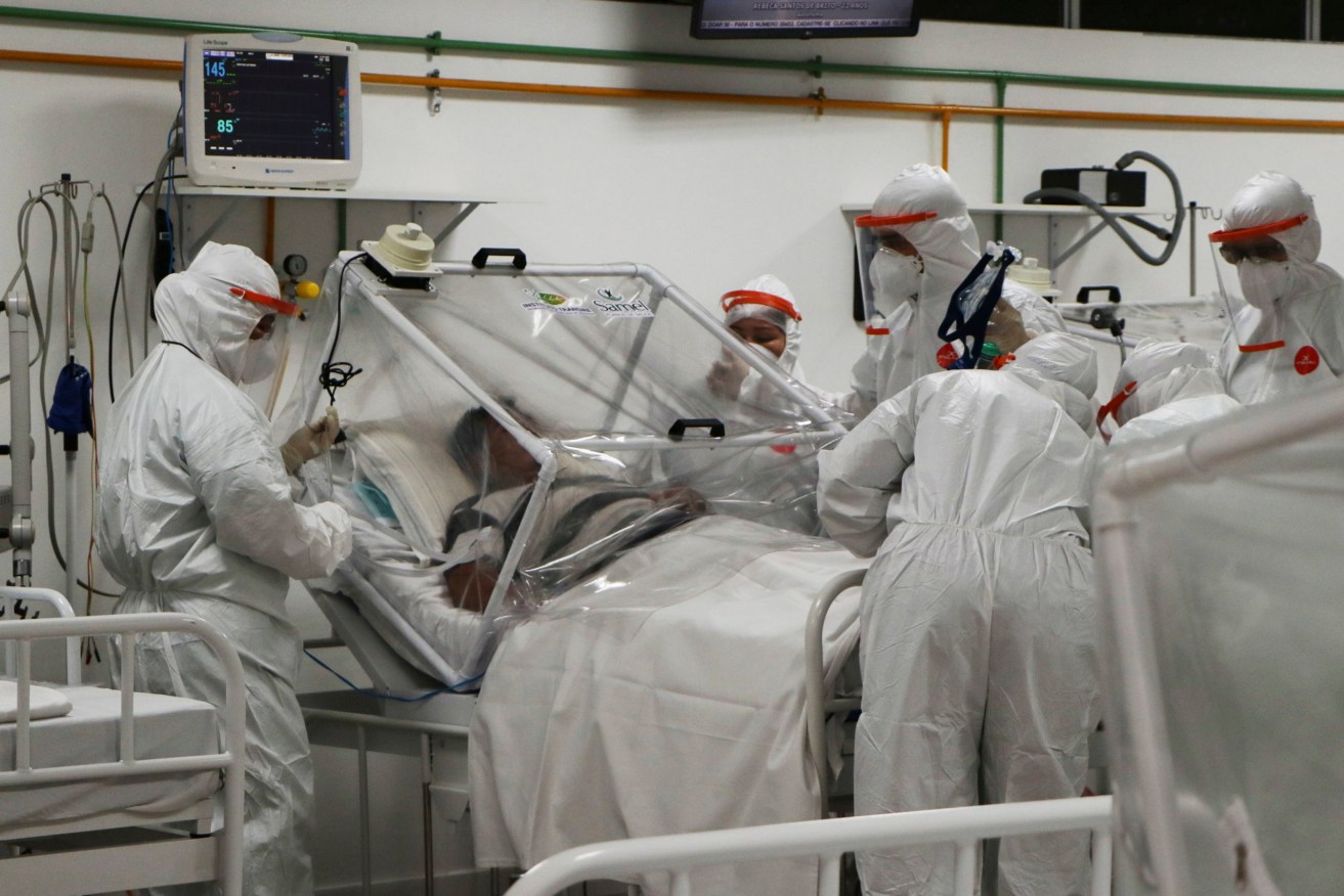 A COVID-19 patient is treated at a hospital in Brazil. Photo:AP/Edmar Barros