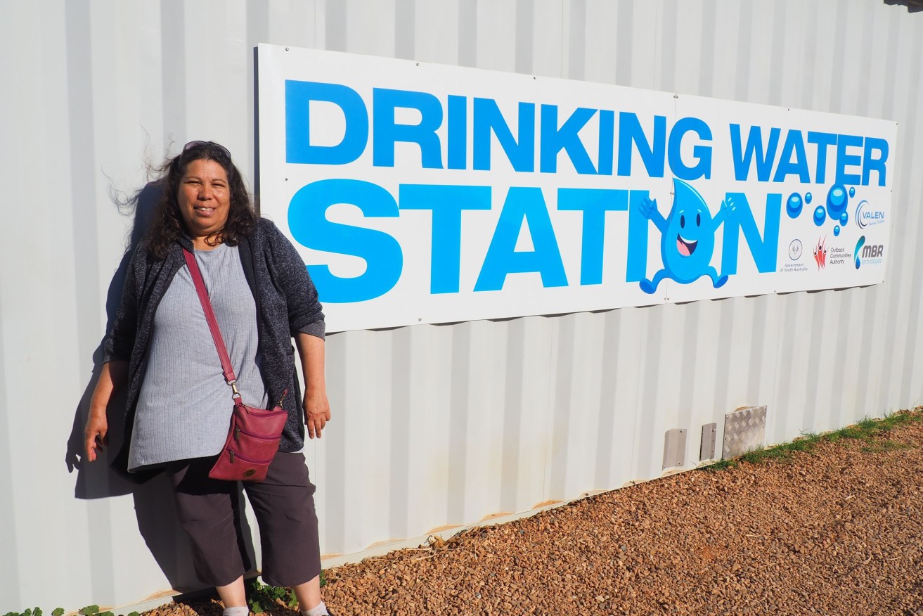 Dunjiba Community Council chair Maria Stewart by Oodnadatta's reverse osmosis water filter. Photo: Stephanie Richards/InDaily 