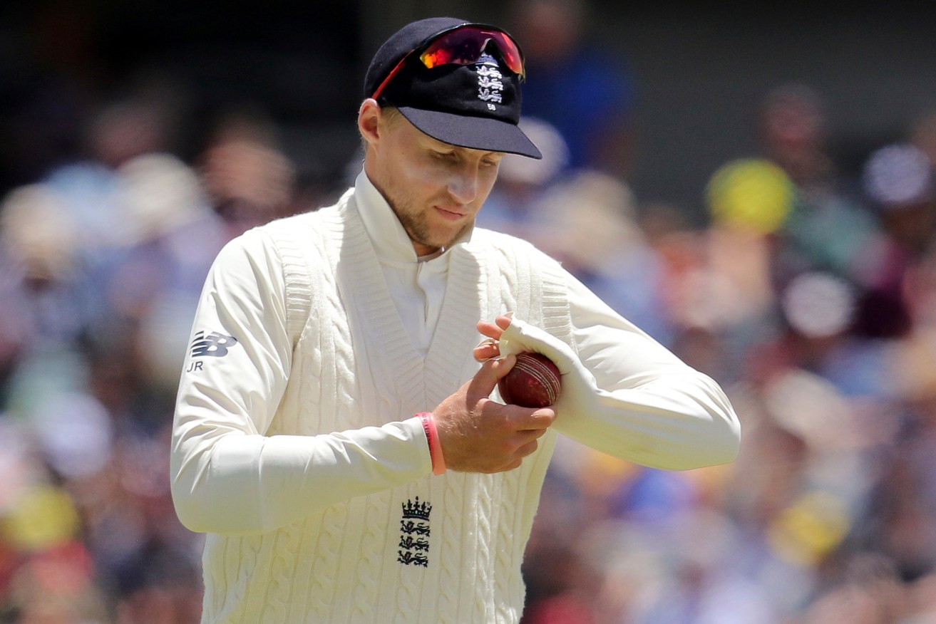 England's Joe Root polishes the ball during an Ashes Test against Australia. Photo: AP/Trevor Collens