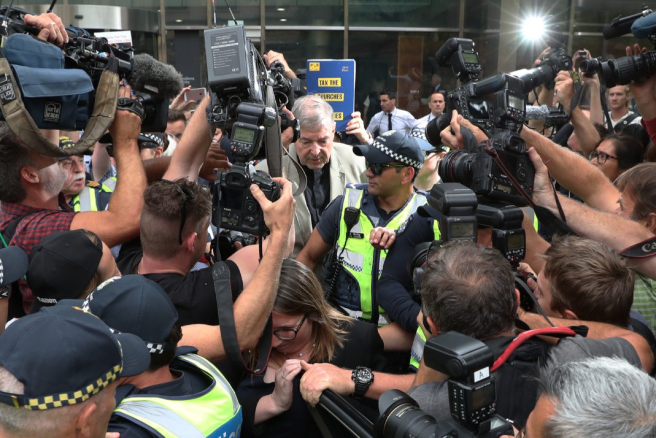 Catholic Cardinal George Pell surrounded by media during his 2019 trial in Melbourne. Photo: AAP/David Crosling