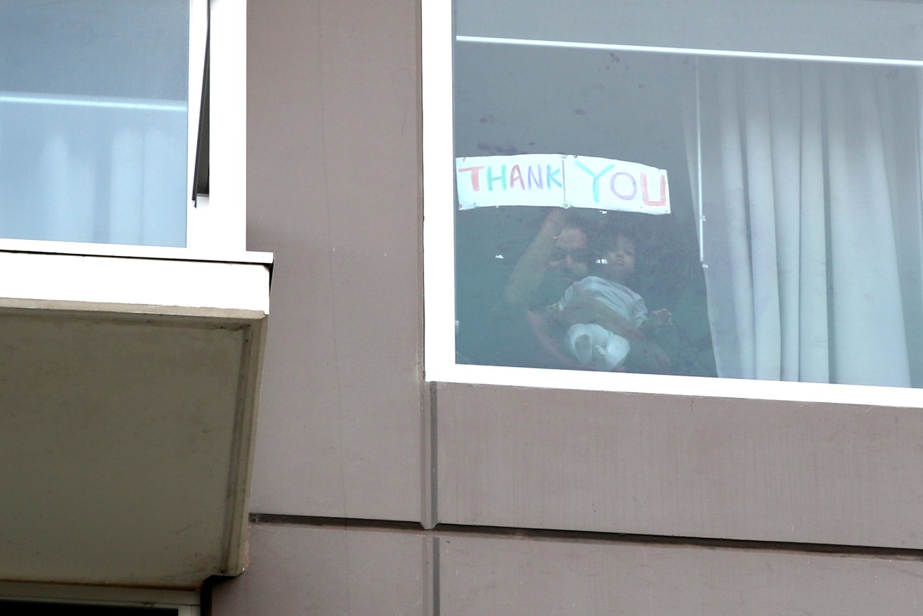 A Thank You sign is held up inside Adelaide's Pullman Hotel as hundreds of repatriated Australians prepare to end 14 days isolation. Photo: AAP/Kelly Barnes