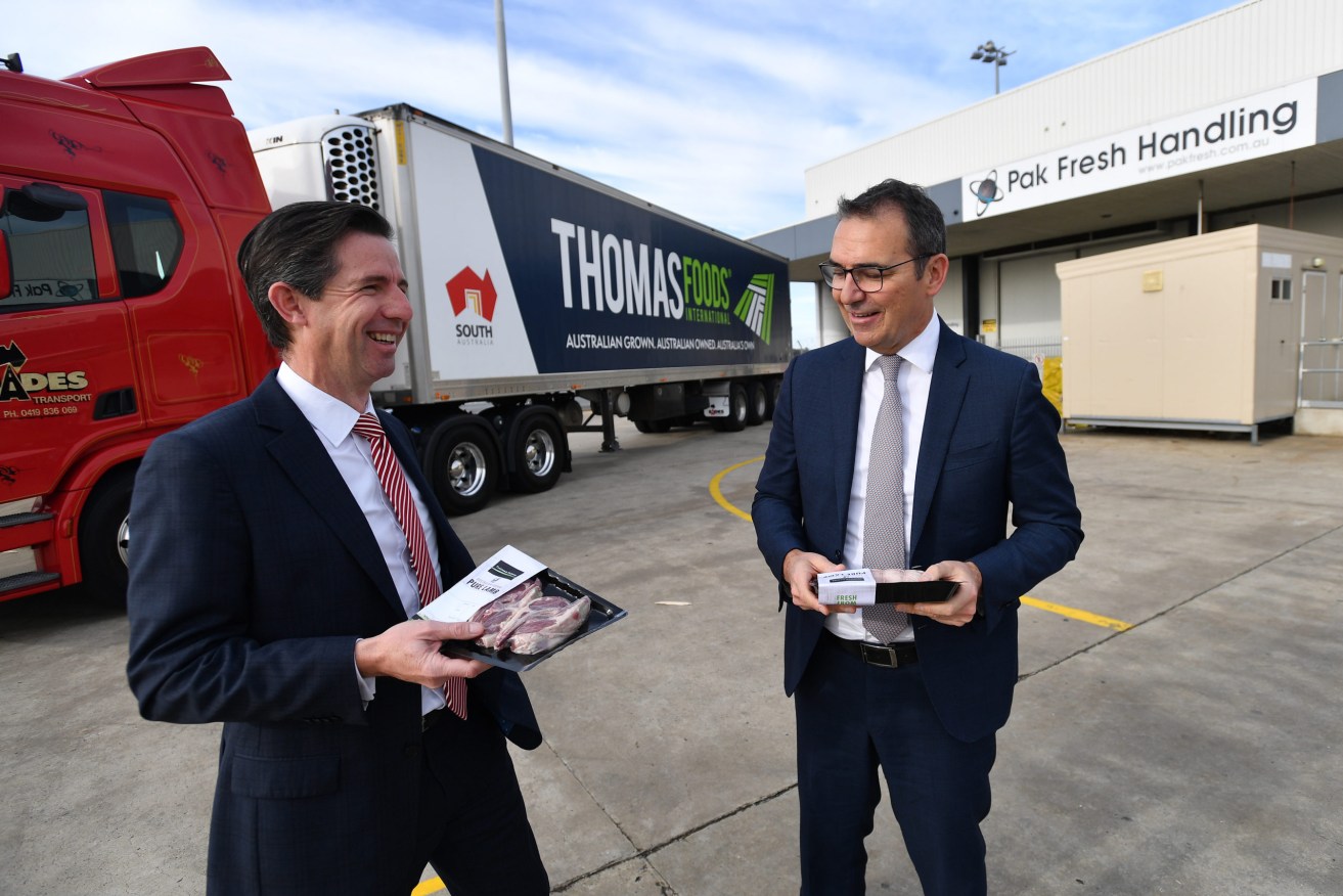 Trade minister Simon Birmingham and Premier Steven Marshall wave off a flight of SA food exports to Asia. Photo: AAP/David Mariuz 