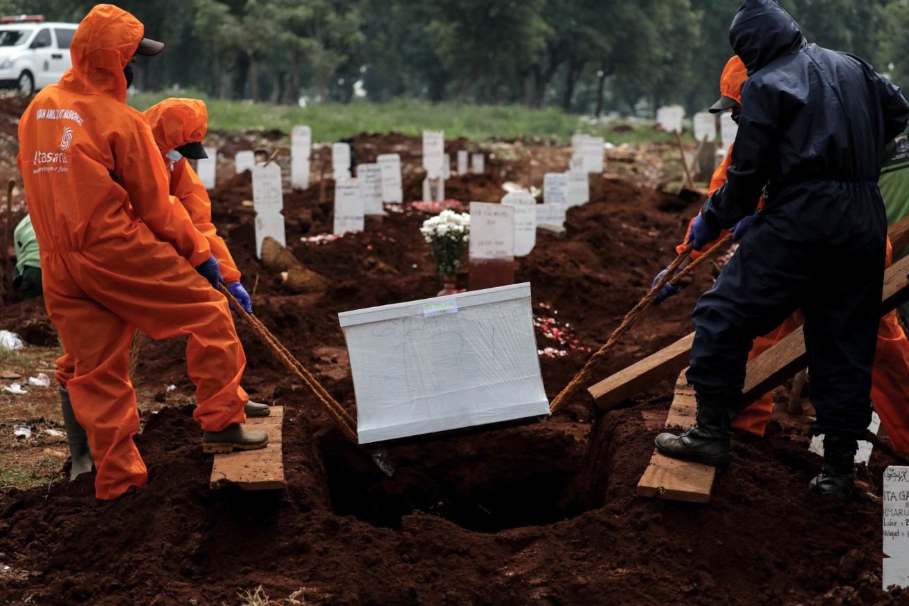 Another burial at a designated COVID-19 graveyard in Jakarta, Indonesia. Photo: Risa Krisadhi/Pacific Press/Sipa USA