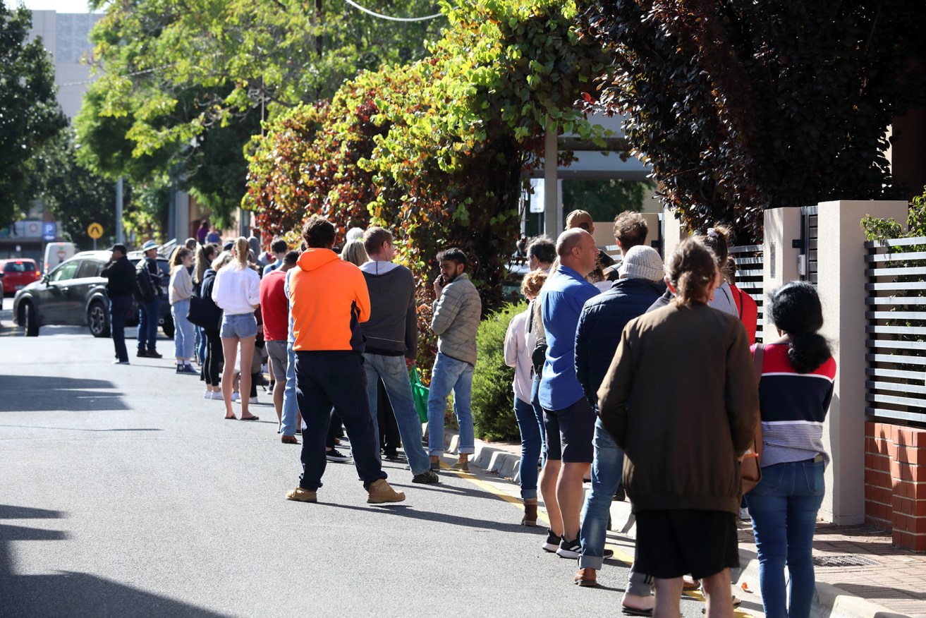 People queue around the corner from an Adelaide Centrelink office. Photo: Tony Lewis/InDaily