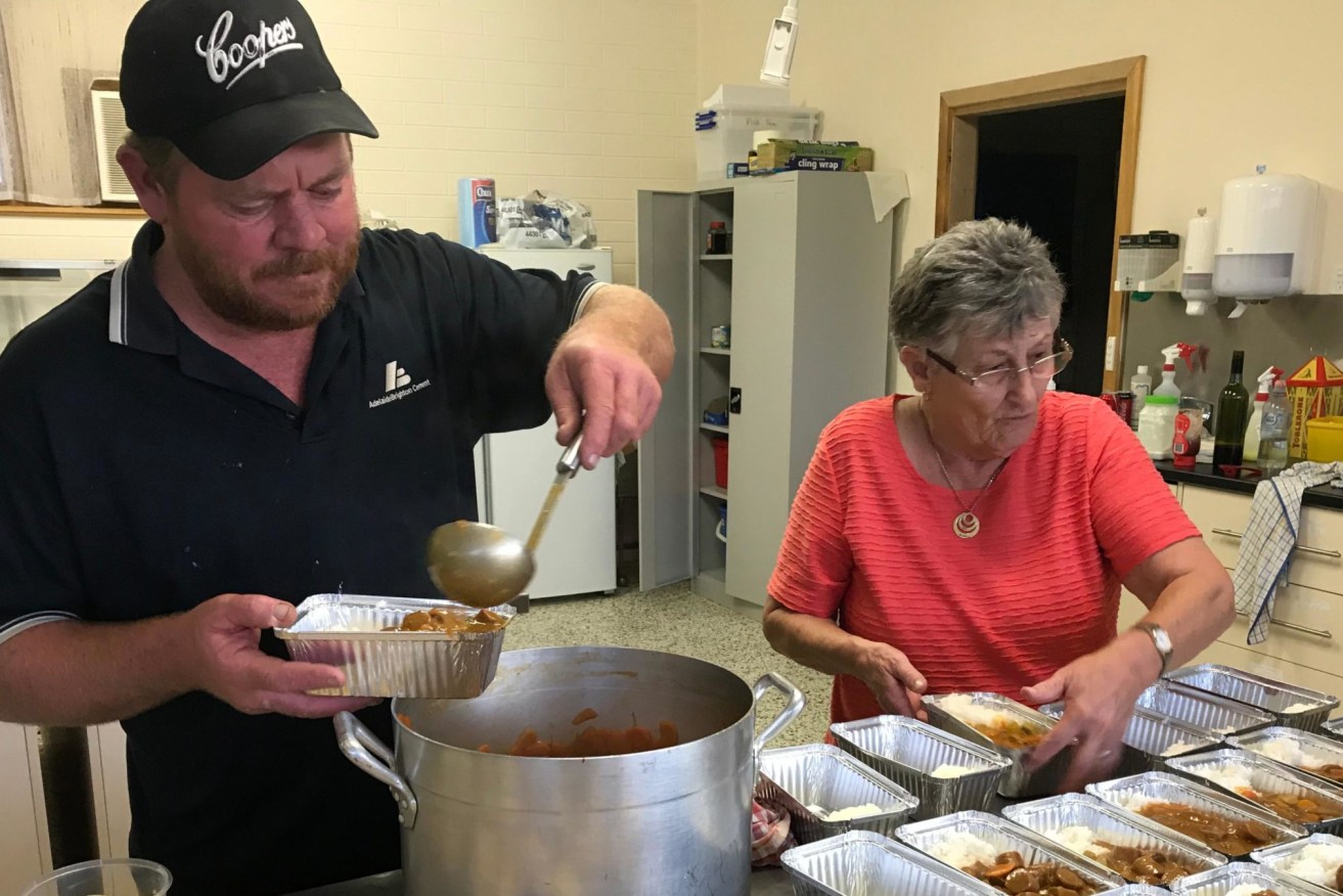 The Waikerie Bowling Club’s Nathan Cronin and Kerry Rogers prepare meals for their self-isolating elderly members.