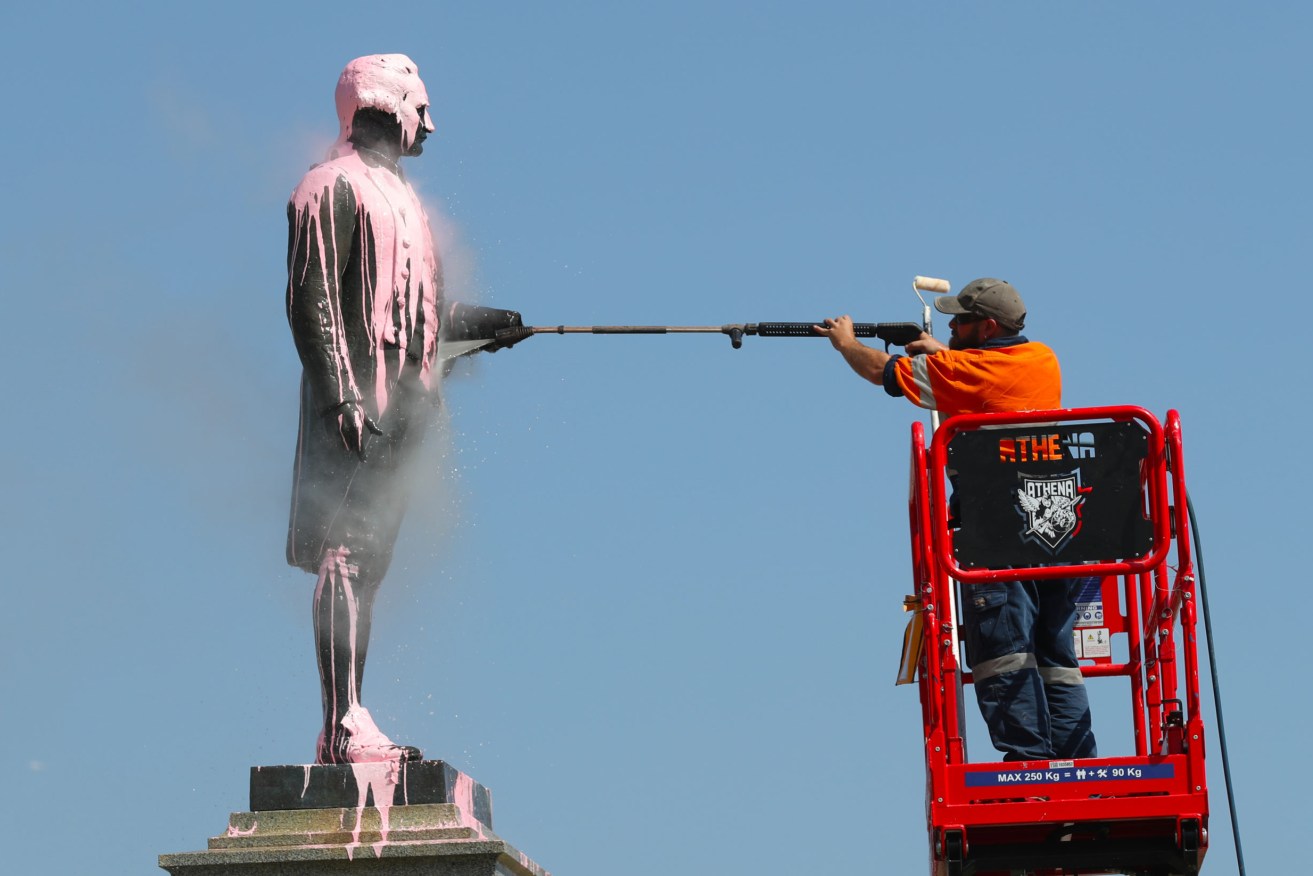 A Captain Cook statue is cleaned after being targeted in Melbourne. Photo: AAP/David Crosling
