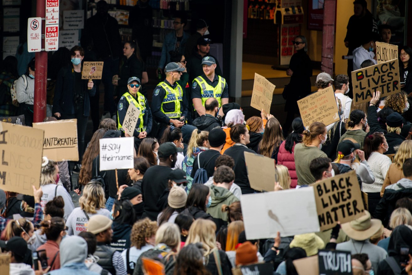 Police watch on at last weekend's Black Lives Matter rally in Adelaide. Photo: Morgan Sette / AAP