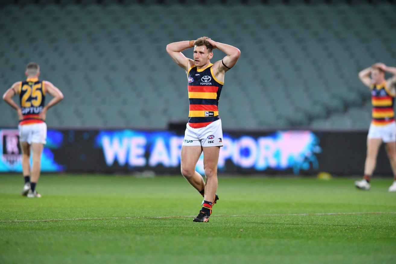 Crows players sensibly avoiding the spread of coronavirus by staying well away from their opponents in Saturday's Showdown. Photo: David Mariuz / AAP