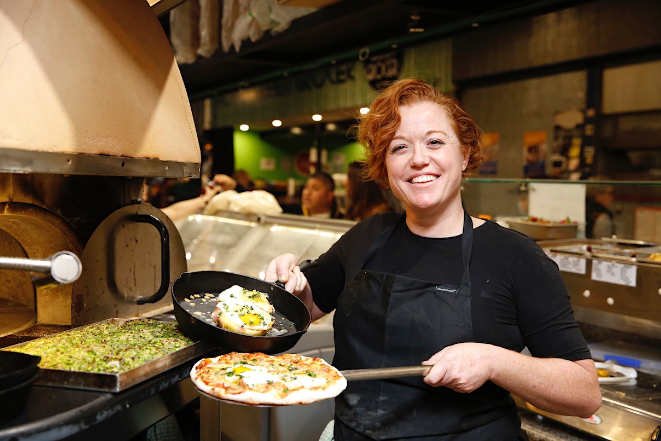 Missy Belmont with Atlas Continental's breakfast pizza and potatoes at Adelaide Central Market. Photo: Ben Kelly