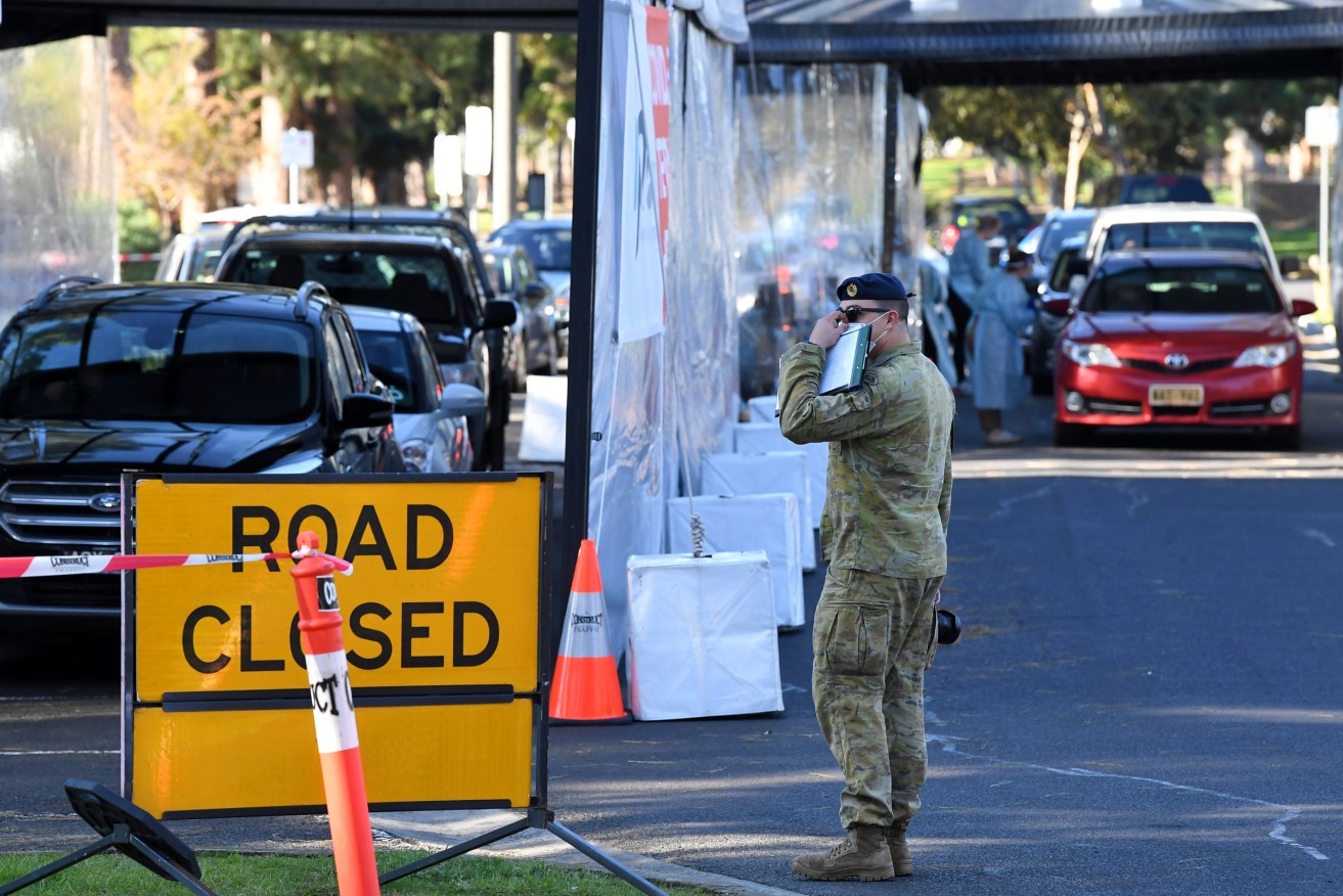 An Australian Defence Force member at a drive through Covid-19 testing facility in Melbourne. Photo: AAP/James Ross